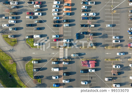 Aerial view of many colorful cars parked on parking lot with lines and markings for parking places and directions 99333070