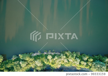 Aerial view of fish hetching pond with blue water in aquacultural area Aerial view of fish hetching pond with blue water in aquacultural area 99333159