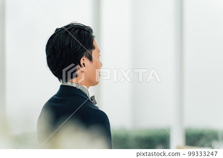 A groom/groom man waiting for a bride to walk on a virgin road at a wedding hall/chapel A groom/groom man waiting for a bride to walk on a virgin road at a wedding hall/chapel 99333247