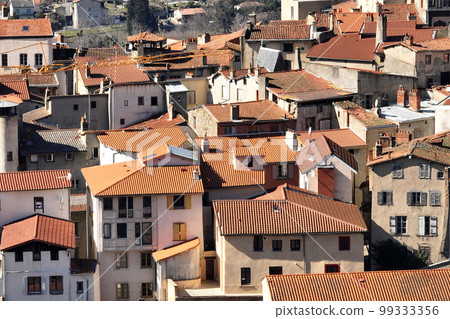 Aerial view of dense historic center of Thiers town in Puy-de-Dome department, Auvergne-Rhone-Alpes region in France. Rooftops of old buildings and narrow streets Aerial view of dense historic center of Thiers town in Puy-de-Dome department, Auvergne-Rhone-Alpes region in France. Rooftops of old buildings and narrow streets 99333356