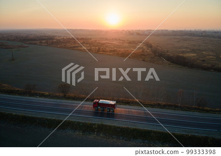 Aerial view of cargo truck driving on highway hauling goods. Delivery transportation and logistics concept Aerial view of cargo truck driving on highway hauling goods. Delivery transportation and logistics concept 99333398