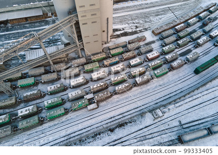 Aerial view of cargo train cars loaded with construction goods at mining factory. Railway transportation of industrial production raw materials 99333405