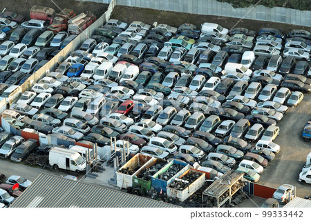 Aerial view of big parking lot of junkyard with rows of discarded broken cars. Recycling of old vehicles 99333442