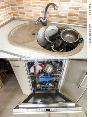 Dirty sink with kitchenware, utensil, dishes. Open dishwasher with clean dishes. 99333863