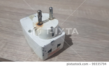 Burnout electrical appliances or electrical plug or electrical adapter dangerous 99335794