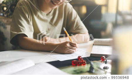 Woman hand writing for create story setup adventure role playing tabletop and board game hobby Woman hand writing for create story setup adventure role playing tabletop and board game hobby 99336948