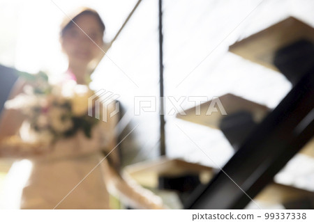 Young woman in a wedding dress blurred wedding image Young woman in a wedding dress blurred wedding image 99337338