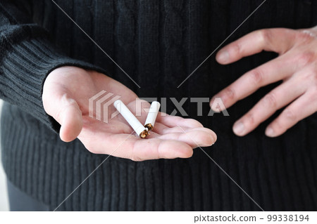 Hand of a man who decided to quit smoking Hand of a man who decided to quit smoking 99338194