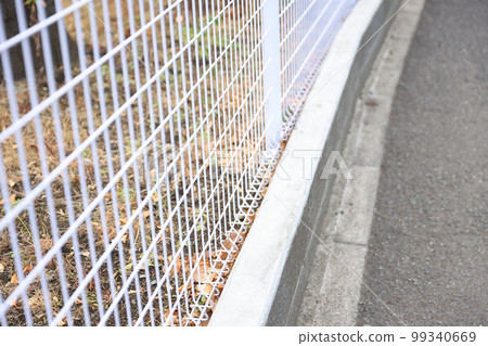 Sidewalks, iron net fences and stone walls Sidewalks, iron net fences and stone walls 99340669