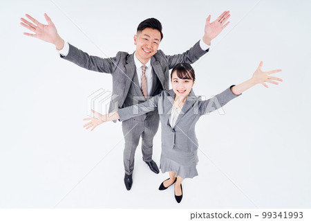 Men and women in suits posing positively Men and women in suits posing positively 99341993