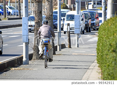 Cheerful senior riding a bicycle 99342911