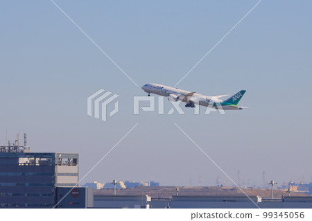 A passenger plane gliding, taking off, and rising against the background of Tokyo SAF A passenger plane gliding, taking off, and rising against the background of Tokyo SAF 99345056