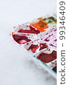Part of white palette with watercolors on light blurred background, horizontal photo. 99346409