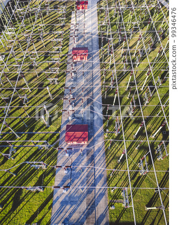 Top down view of electrical wires running around at the electrical substation  99346476