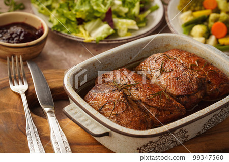 Roasted duck breasts served with vegetables and cranberry dip. Roasted duck breasts served with vegetables and cranberry dip. 99347560