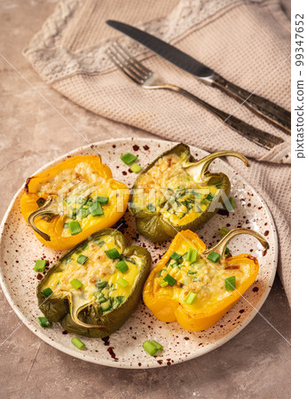 Keto diet dish - pepper stuffed with eggs, cheese and bacon , baked in oven. 99347652