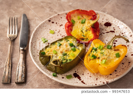Keto diet dish - pepper stuffed with eggs, cheese and bacon , baked in oven. 99347653