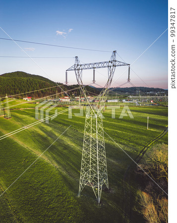 Vertical phot of electrical tower on a grass field in the country side of Slovenia Vertical phot of electrical tower on a grass field in the country side of Slovenia 99347817