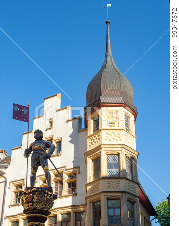 Biel, Switzerland - April 16th 2023: A statue in front of a historic housing building Biel, Switzerland - April 16th 2023: A statue in front of a historic housing building 99347872