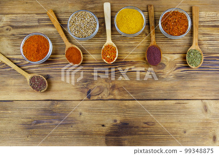 Set of different aromatic spices on wooden table. Top view, copy space Set of different aromatic spices on wooden table. Top view, copy space 99348875