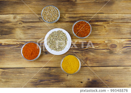Set of different aromatic spices on wooden table. Top view 99348876