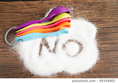 No sugar, sweet granulated sugar with text, diabetes prevention, diet and weight loss for good health. 99349965