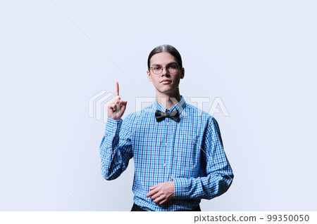 Serious guy student showing thumbs up, over white background 99350050
