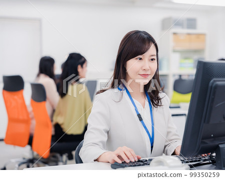 A woman doing desk work with a smile 99350259