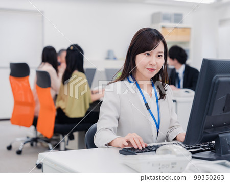 A woman doing desk work with a smile 99350263