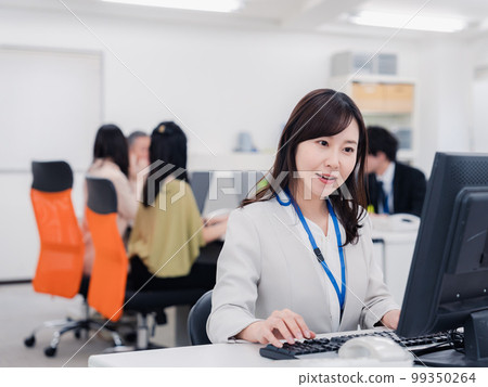 A woman doing desk work with a smile 99350264