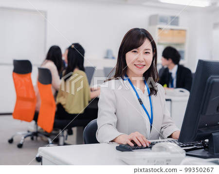 A woman doing desk work with a smile 99350267
