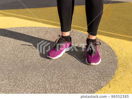 Athlete feet in sneakers. Woman doing sport outdoors. Healthy lifestyle, training concept. 99352385