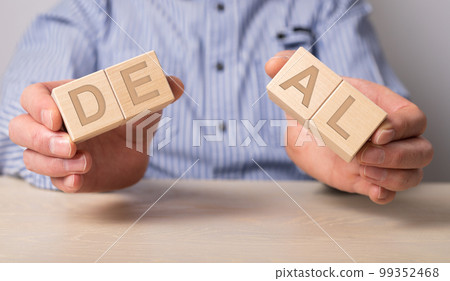 Man holding divided blocks of word deal. Breaking contract, refusal to renew agreement. Anticipatory repudiation act. End of cooperation. Violation of conditions and rules. Man holding divided blocks of word deal. Breaking contract, refusal to renew agreement. Anticipatory repudiation act. End of cooperation. Violation of conditions and rules. 99352468