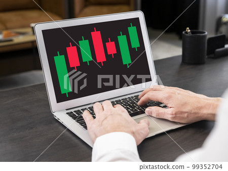 Businessman working with candlestick graph at laptop. Stock value behavior analysis. Investment, analytics and trade concept. Man hands at keyboard Businessman working with candlestick graph at laptop. Stock value behavior analysis. Investment, analytics and trade concept. Man hands at keyboard 99352704