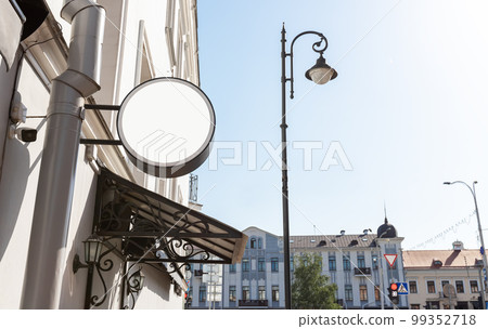 Old city signboard mockup. Board of round shape on cafe, hotel, museum, bookstore wall for service advertisement 99352718