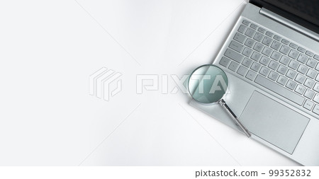 Technology banner with laptop keyboard and magnifying lens with copy space for text 99352832