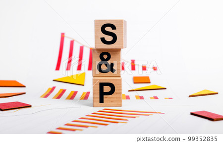 SP 500 index decline. Economic recession and crisis concept. Cubes with Standard and Poor abbreviation and charts showing shares dropping. Investment and trade concept. 99352835