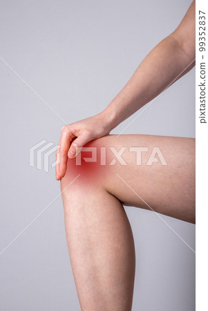 Woman suffering from knee pain. Hand holding leg with red spot closeup. Joint injury, tendon problems. Health care, medicine concept 99352837