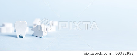 Fake toy teeth on blue dental banner with copy space for text. Dentists ad Fake toy teeth on blue dental banner with copy space for text. Dentists ad 99352952