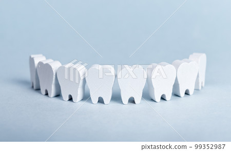 Toy teeth row on blue background 99352987