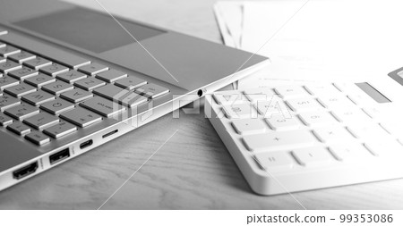 Laptop and calculator at table. Accountant job, workplace. Statistic data, analytic report preparing. Laptop and calculator at table. Accountant job, workplace. Statistic data, analytic report preparing. 99353086