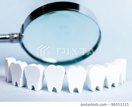 Teeth in smile form with magnifying glass. Dental checkup, tooth, gums, mouth examination concept. Routine visit to dentist and checking for cavity, plaque, periodontal disease 99353115
