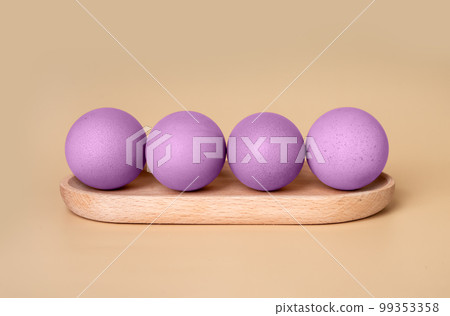 Purple dyed Easter eggs at wooden server on beige background. Preparation to religious holiday celebration concept in minimalism style. 99353358