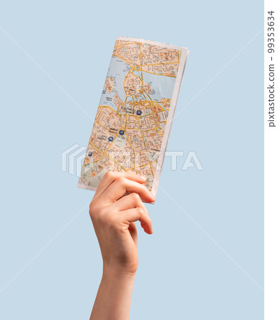 Woman hand holding tourist map, guide. Travelling, going abroad, visiting places of interests, attractions concept. Woman hand holding tourist map, guide. Travelling, going abroad, visiting places of interests, attractions concept. 99353634