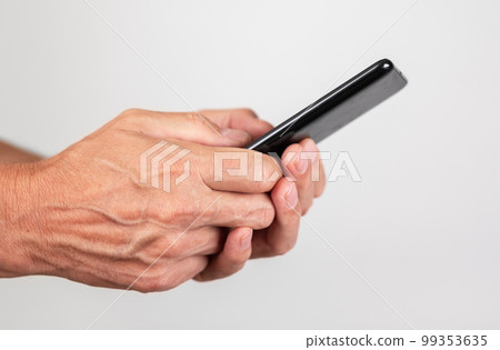 Man hands closeup texting message at phone. Male using messenger or searching information on Internet. Man hands closeup texting message at phone. Male using messenger or searching information on Internet. 99353635
