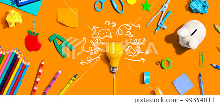 Brainstorming concept with a light bulb and school supplies 99354011