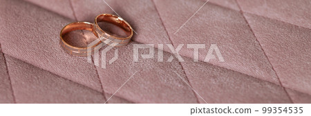 Banner two gold wedding rings.  99354535