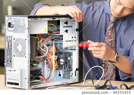 Young man opening the desktop PC to work Setting kitting business image 99355455