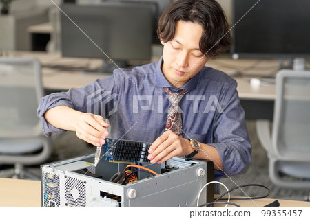 Male staff who opens the PC and sets the board Setting Kitting Business image 99355457
