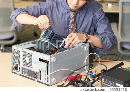 Male staff who opens the PC and sets the board Setting Kitting Business image Male staff who opens the PC and sets the board Setting Kitting Business image 99355458